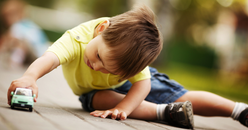 kid playing with toy car